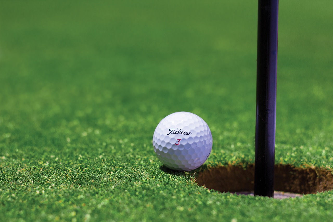 Golf Ball Next To Hole
